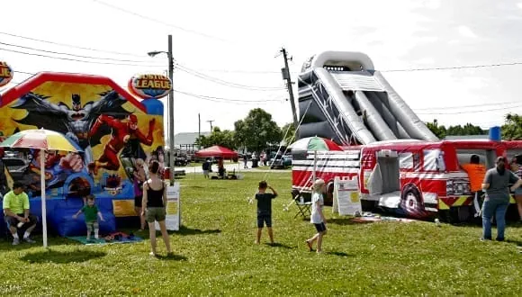 Bounce houses and an inflatable fire truck slide in Kids Town