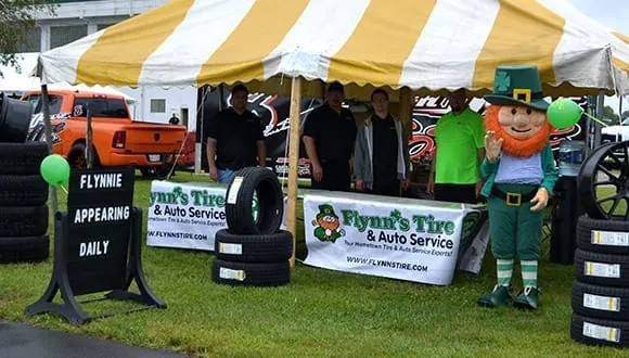 The Flynn's Tire vendor booth and its leprechaun mascot